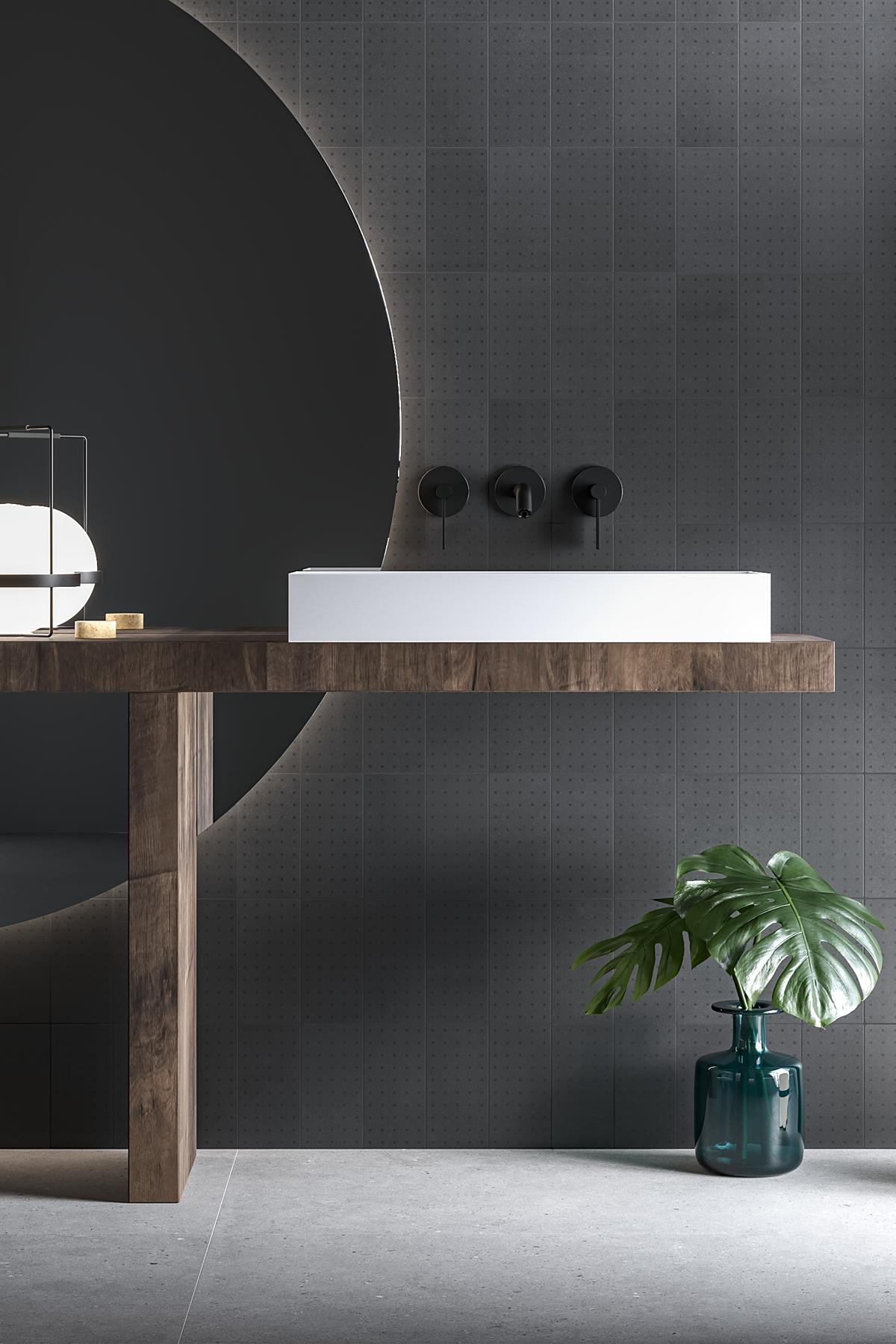 Pared del baño realizada con baldosas de cemento oscuro y diseño en color antracita